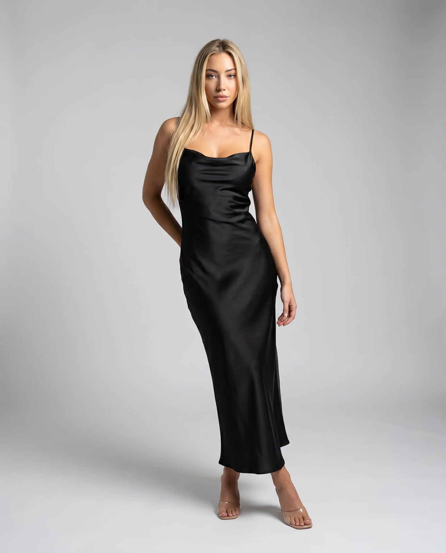 Black satin cowl neck maxi dress with open back detail and timeless evening dress styling by ILYNORA
