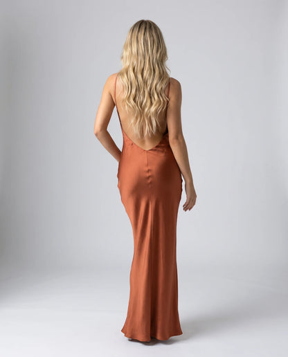 Brown satin cowl neck maxi dress back view with low open back and sleek fitted design by ILYNORA