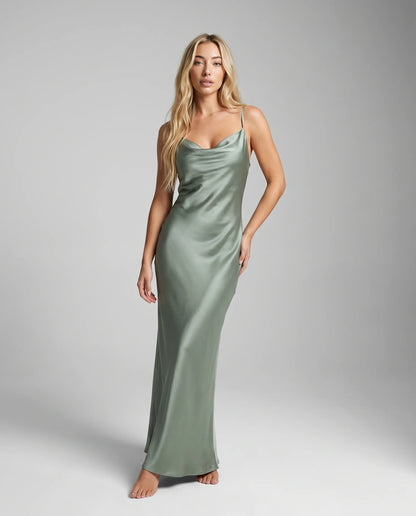 Sage green satin cowl neck maxi dress with elegant drape and minimalist evening wear styling by ILYNORA
