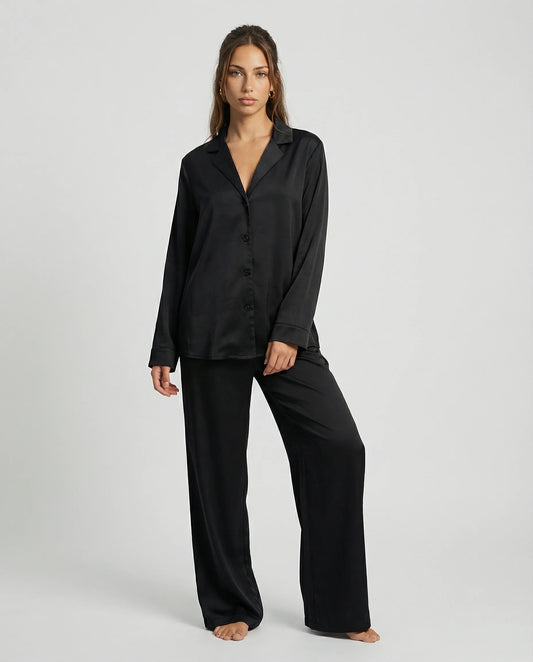 Black satin wide leg pyjama set for women by Ilynora, front view with button-down shirt and relaxed fit