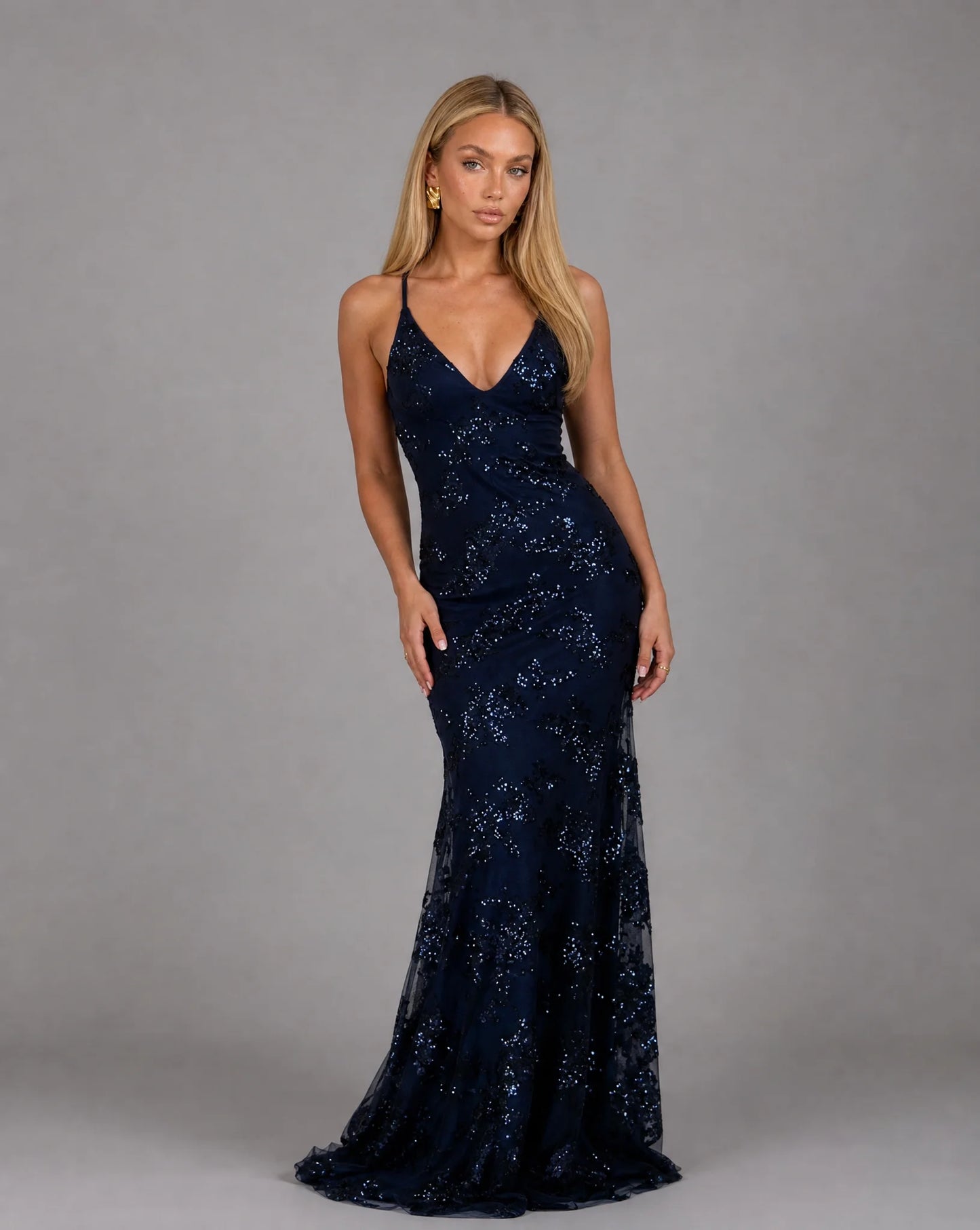 Dark blue sequin evening maxi dress with deep V neckline and glamorous occasion styling by ILYNORA