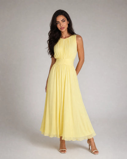 Women's yellow sleeveless chiffon maxi dress with flowing silhouette and elegant summer styling by ILYNORA
