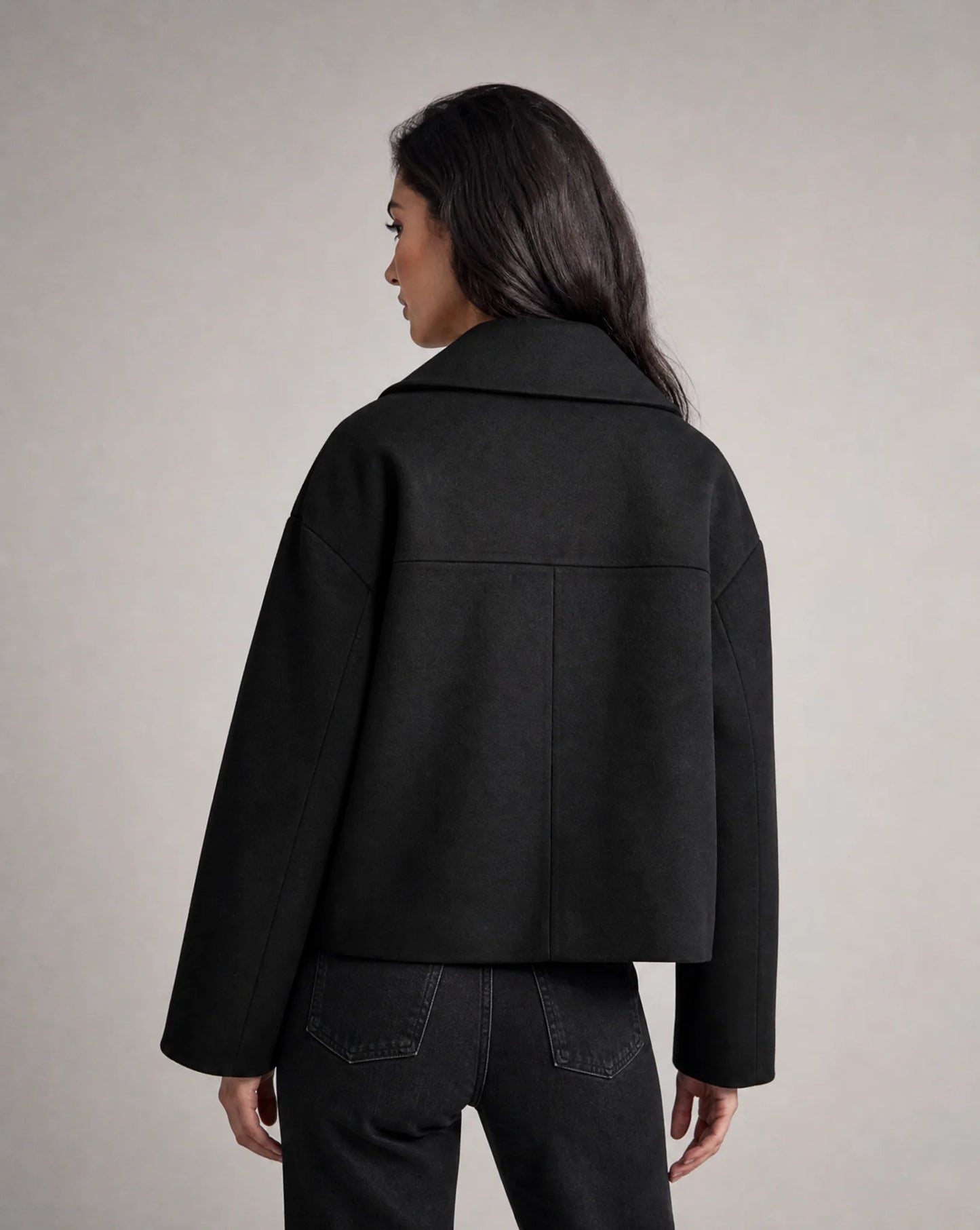 Black structured cropped blazer side view with refined tailoring and polished silhouette by ILYNORA