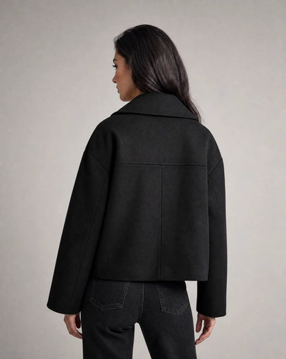 Black structured cropped blazer side view with refined tailoring and polished silhouette by ILYNORA