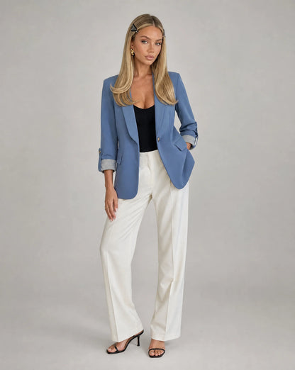 Women's haze blue longline blazer paired with white trousers for polished style by ILYNORA