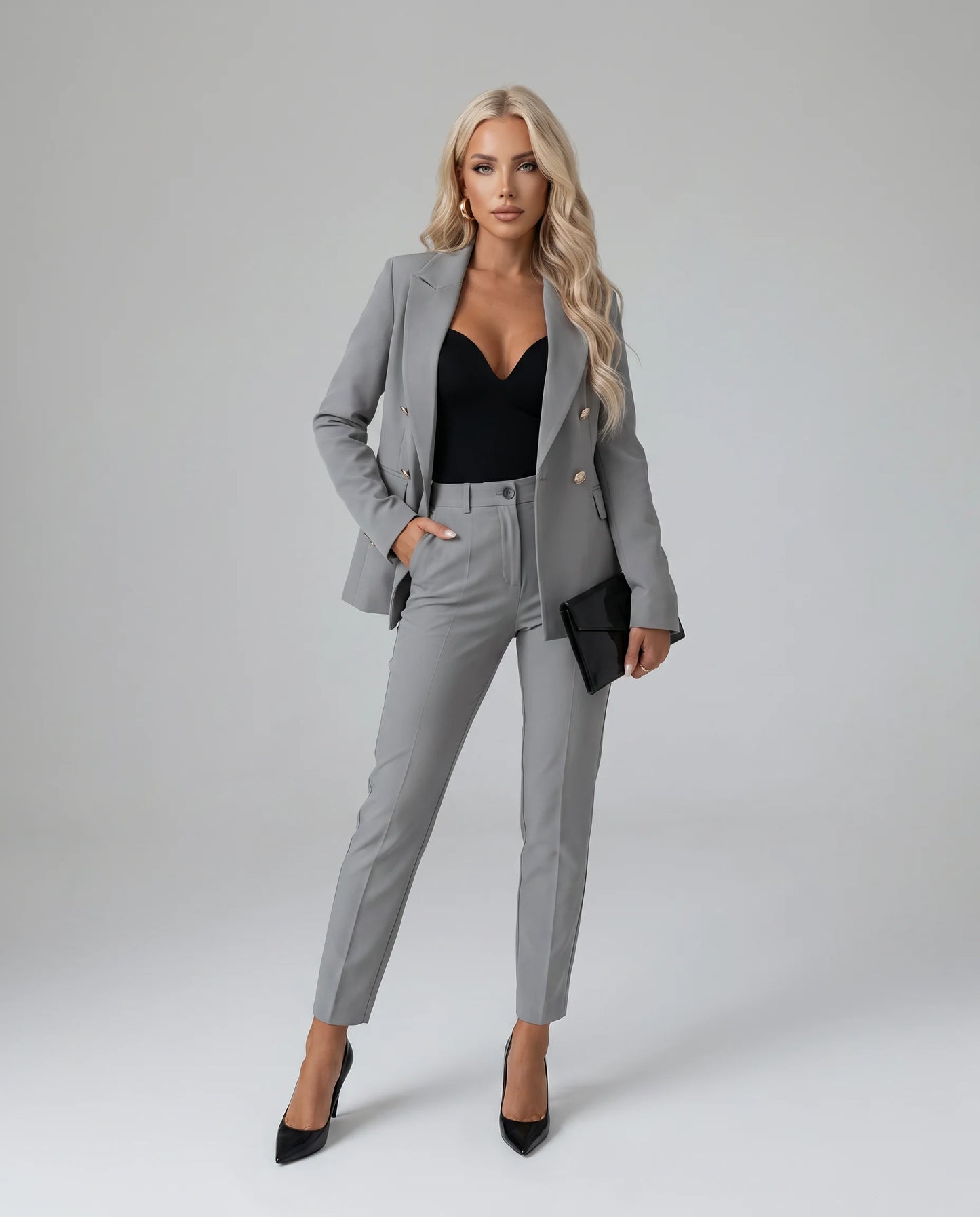 Grey tailored two piece pantsuit with double breasted blazer and sophisticated styling by ILYNORA