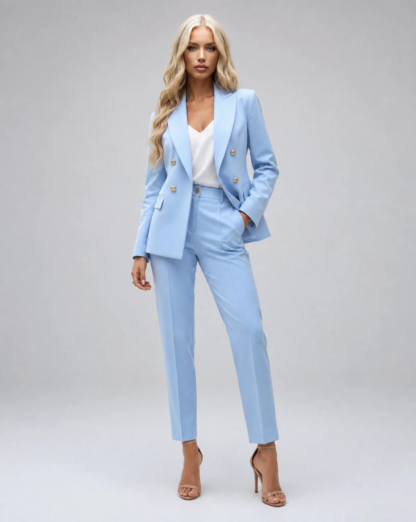 Light blue tailored two piece pantsuit with double breasted blazer and elegant office styling by ILYNORA