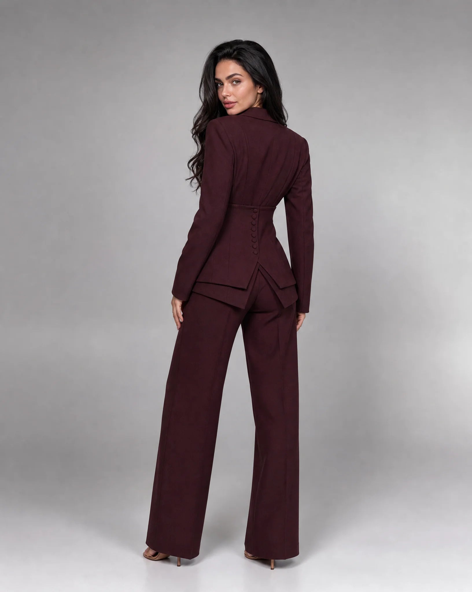 Wine red tailored two piece wide leg suit with structured blazer and matching trousers by ILYNORA
