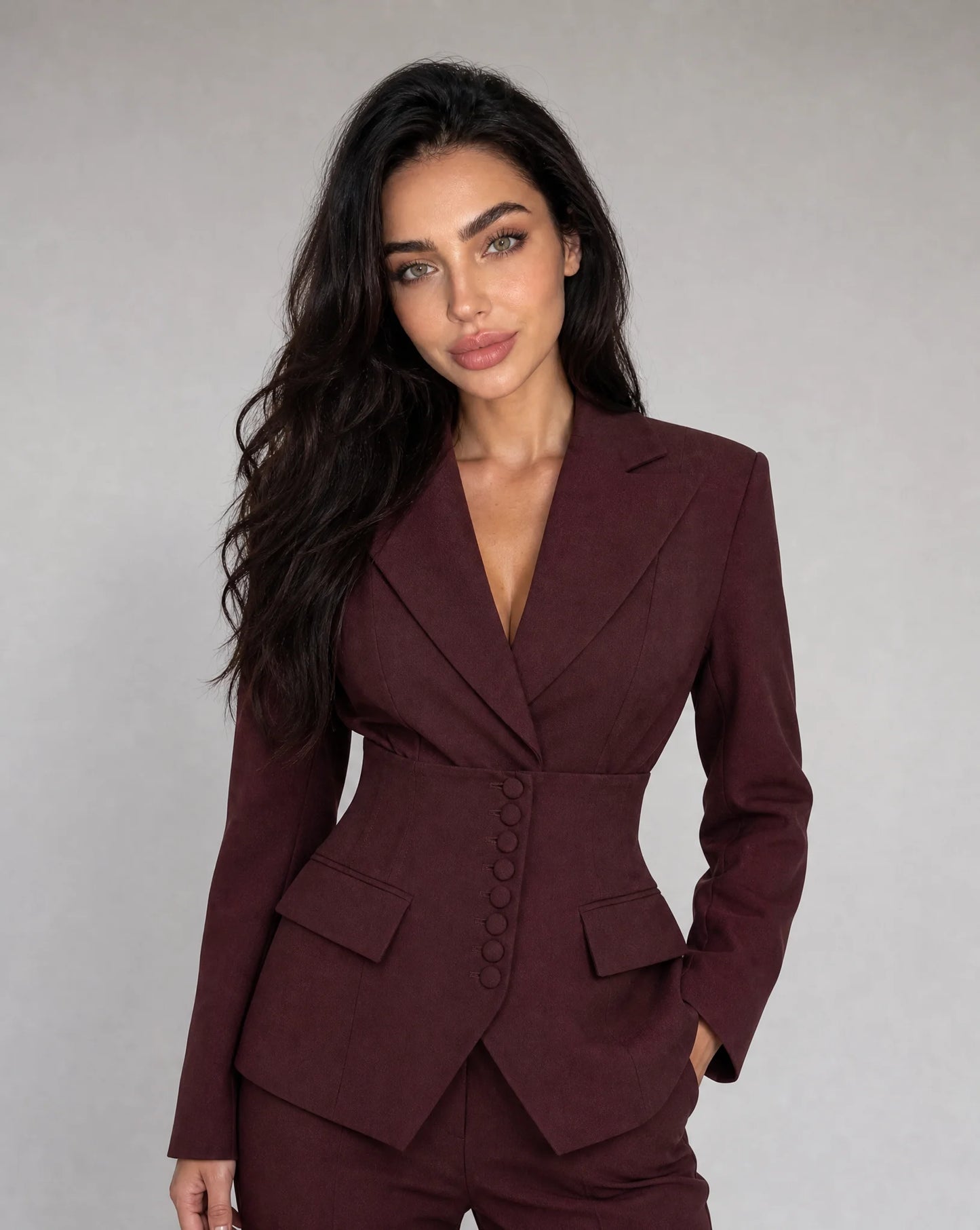 Wine red tailored wide leg trouser suit with peaked lapel blazer and sophisticated silhouette by ILYNORA