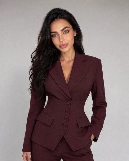 Wine red tailored wide leg trouser suit with peaked lapel blazer and sophisticated silhouette by ILYNORA