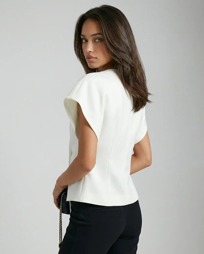 White blouse by Ilynora, side/back view with fluid shape and structured fit