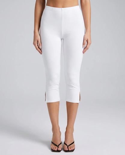 Women's white split hem capri leggings with stretchy slim fit and cropped silhouette by ILYNORA