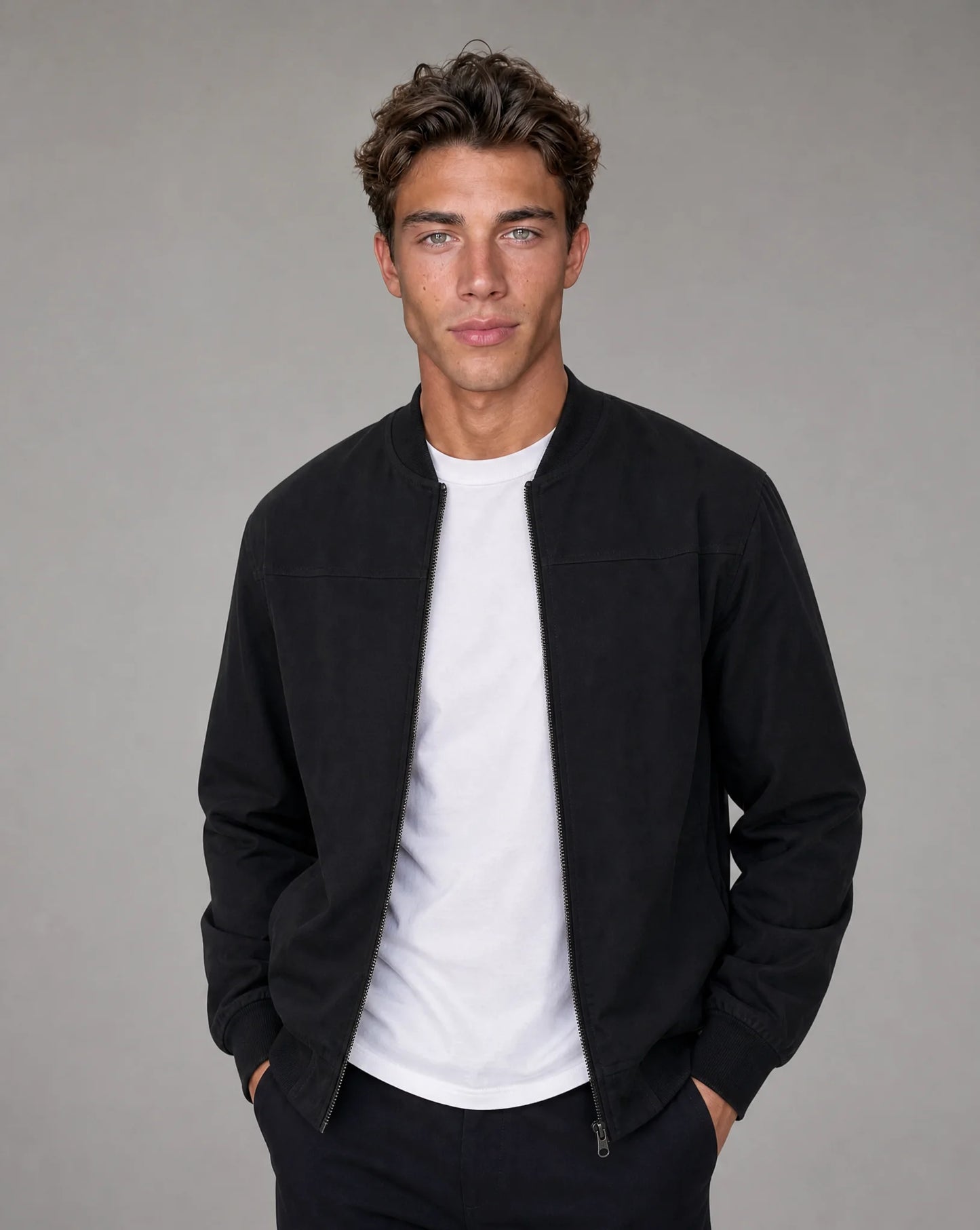 Black zip up bomber jacket for men by Ilynora, front view with ribbed collar and clean modern fit