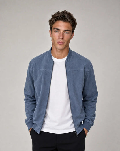 Blue zip up bomber jacket for men by Ilynora, front view with ribbed collar and clean structured silhouette