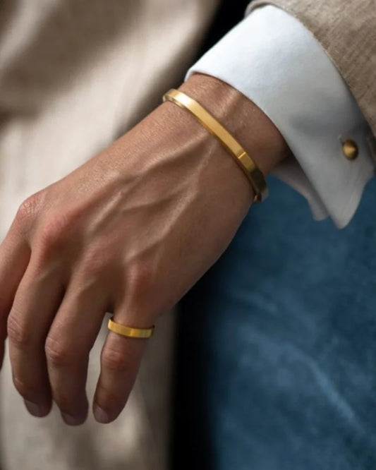 Men’s gold-tone cuff bracelet by Ilynora, worn on wrist with minimal open fit