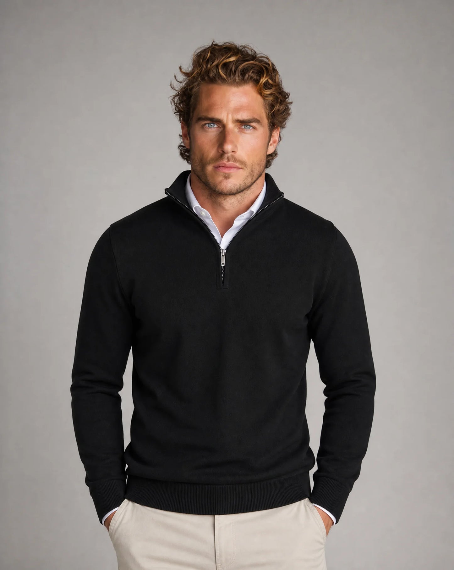 Men's black half-zip knit sweater by ILYNORA styled with tailored trousers for a smart casual look
