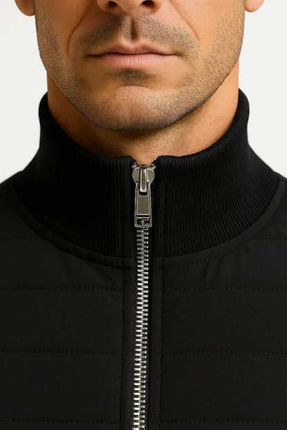 Close-up of ILYNORA men's black hybrid quilted jacket stand collar and front zip