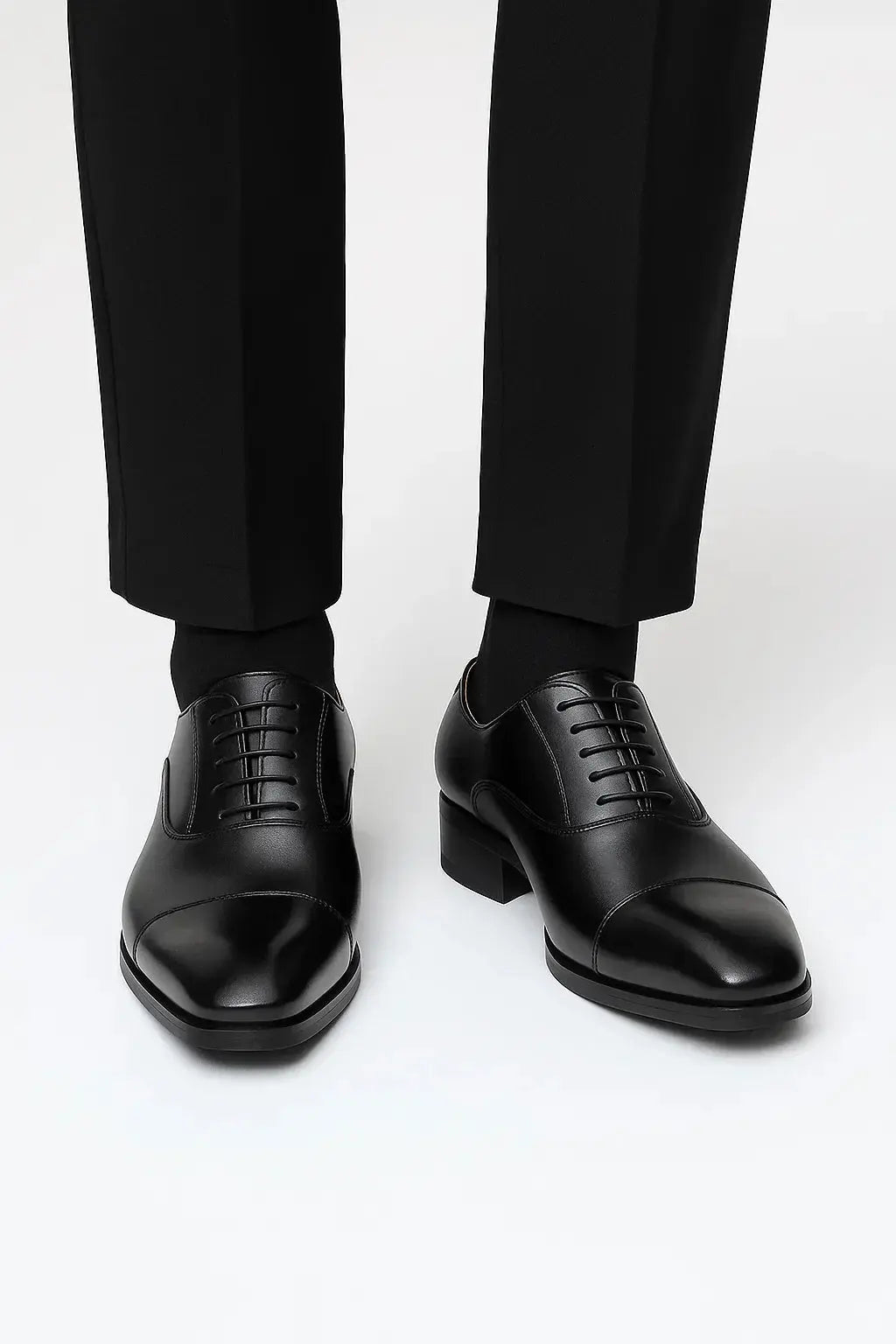 Front view of men's black leather derby dress shoes featuring genuine leather, cap toe design and elegant business styling by ILYNORA
