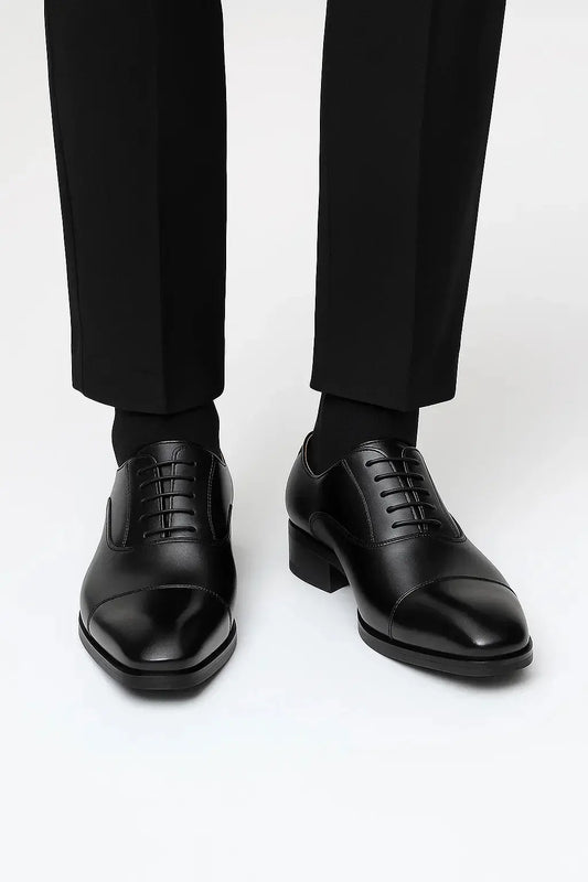 Front view of men's black leather derby dress shoes featuring genuine leather, cap toe design and elegant business styling by ILYNORA