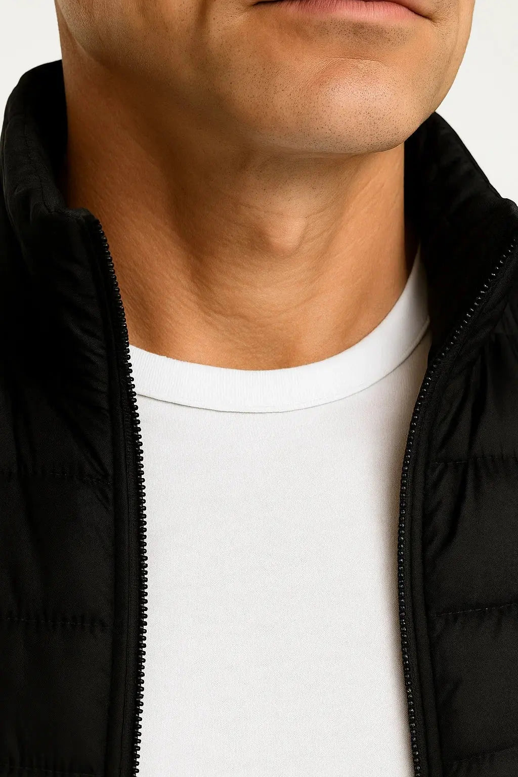 Close-up of men's black lightweight quilted puffer vest showing padded insulation, zip closure and premium finish by ILYNORA