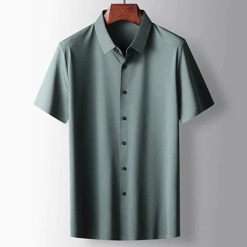 Close-up of men's green silk blend short sleeve shirt featuring premium lightweight fabric, classic collar and smart casual styling by ILYNORA