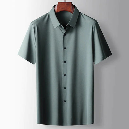Close-up of men's green silk blend short sleeve shirt featuring premium lightweight fabric, classic collar and smart casual styling by ILYNORA