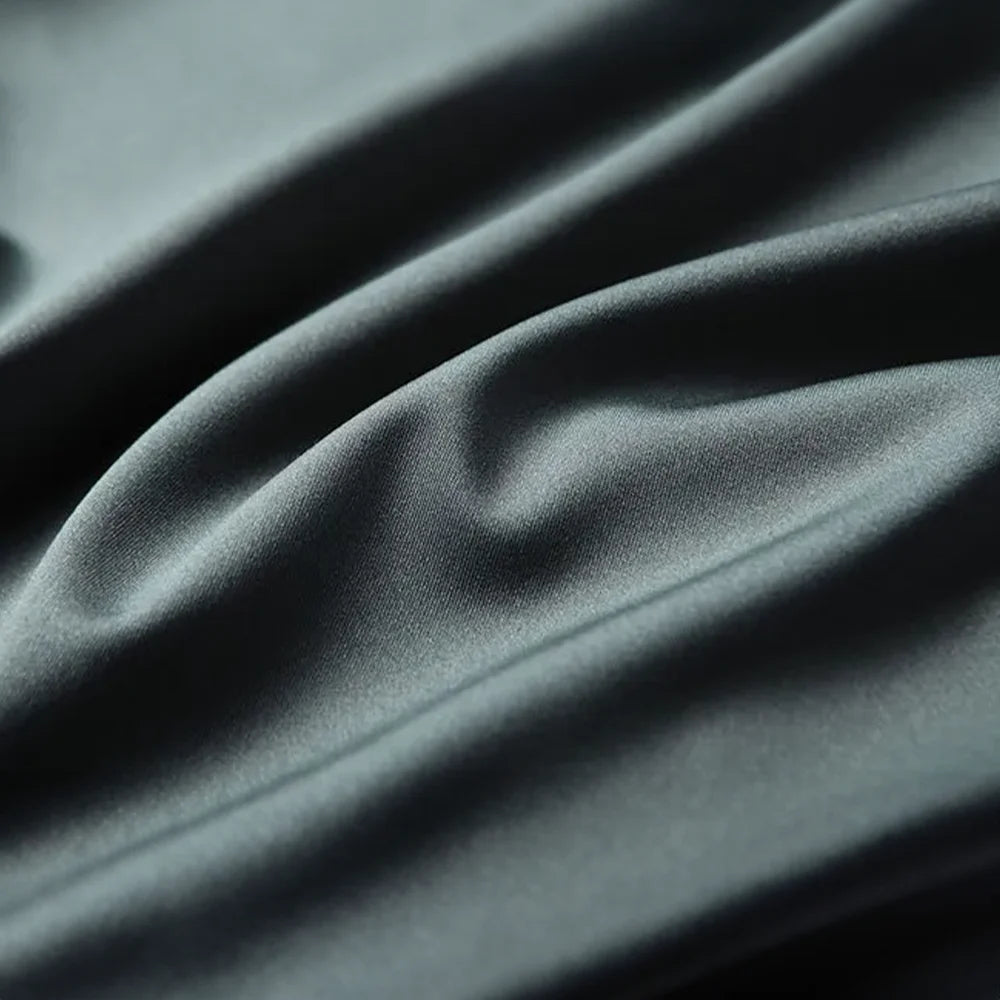 Premium green silk blend fabric showcasing the smooth lightweight texture and luxurious finish of the men's short sleeve shirt by ILYNORA