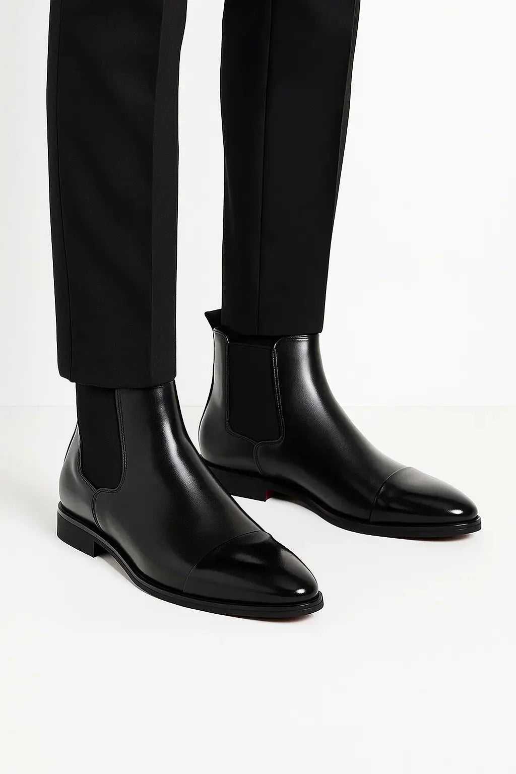 Side view of men's jet black premium leather Chelsea boots with sleek silhouette, pull tab and durable rubber sole by ILYNORA