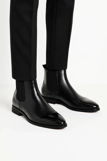 Side view of men's jet black premium leather Chelsea boots with sleek silhouette, pull tab and durable rubber sole by ILYNORA