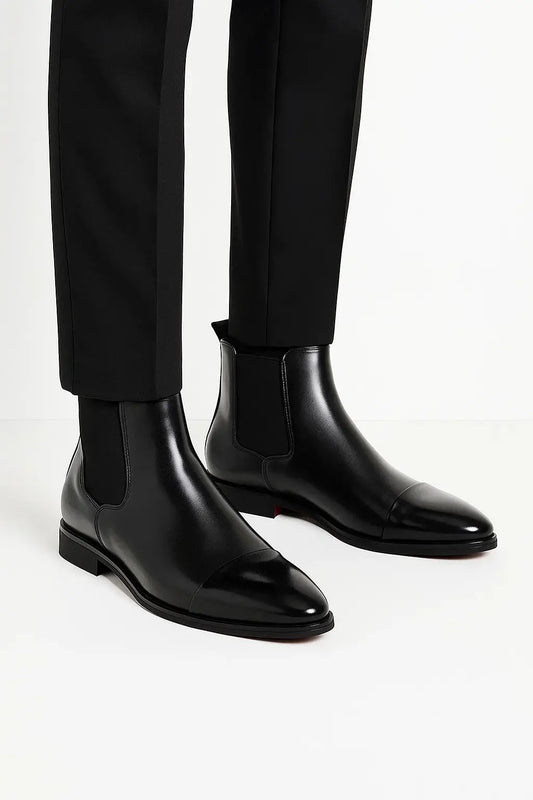 Side view of men's jet black premium leather Chelsea boots with sleek silhouette, pull tab and durable rubber sole by ILYNORA