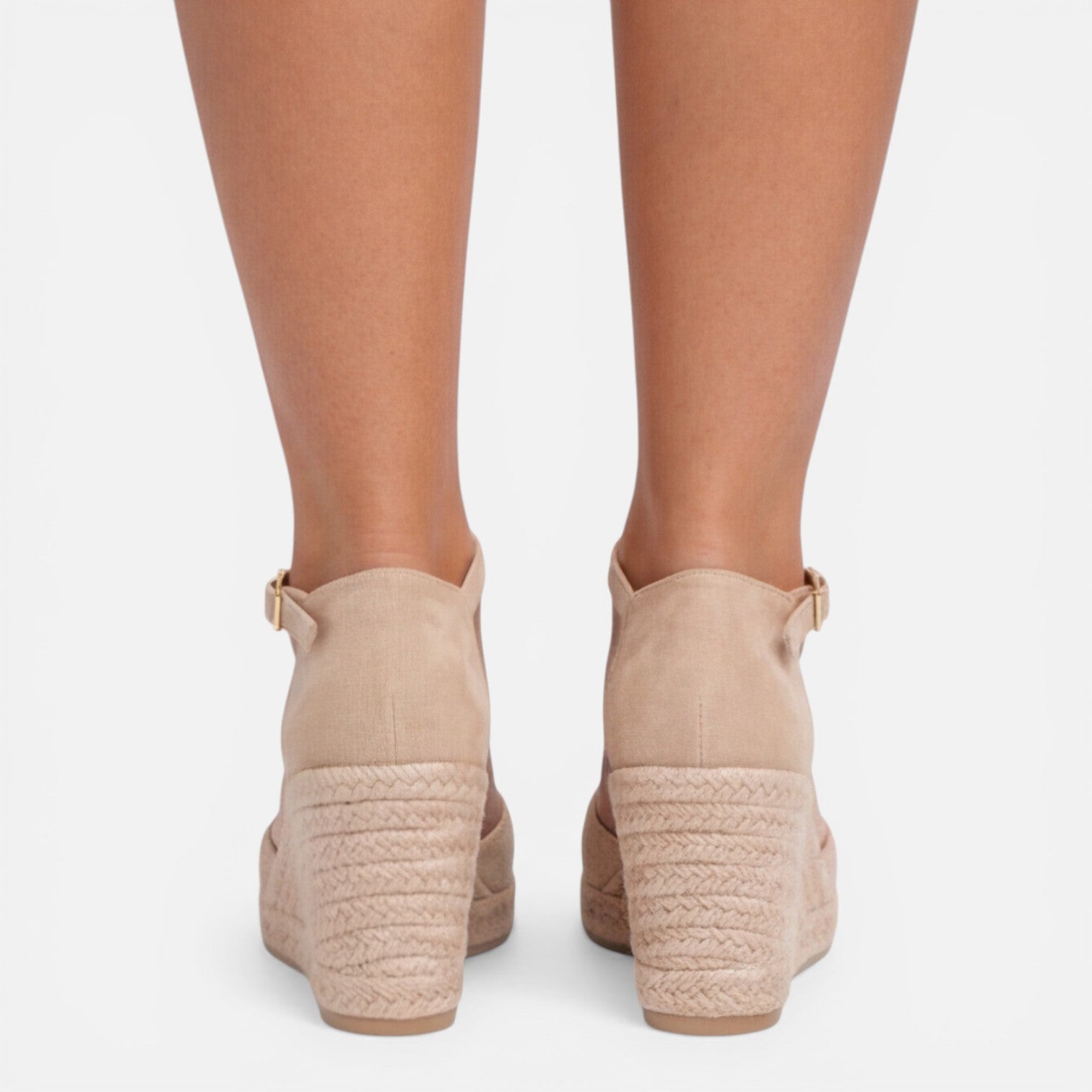 Back view of women's beige closed toe espadrille wedges featuring adjustable ankle strap and braided jute wedge by ILYNORA