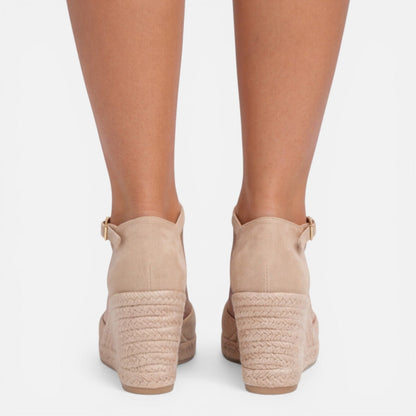 Back view of women's beige closed toe espadrille wedges featuring adjustable ankle strap and braided jute wedge by ILYNORA
