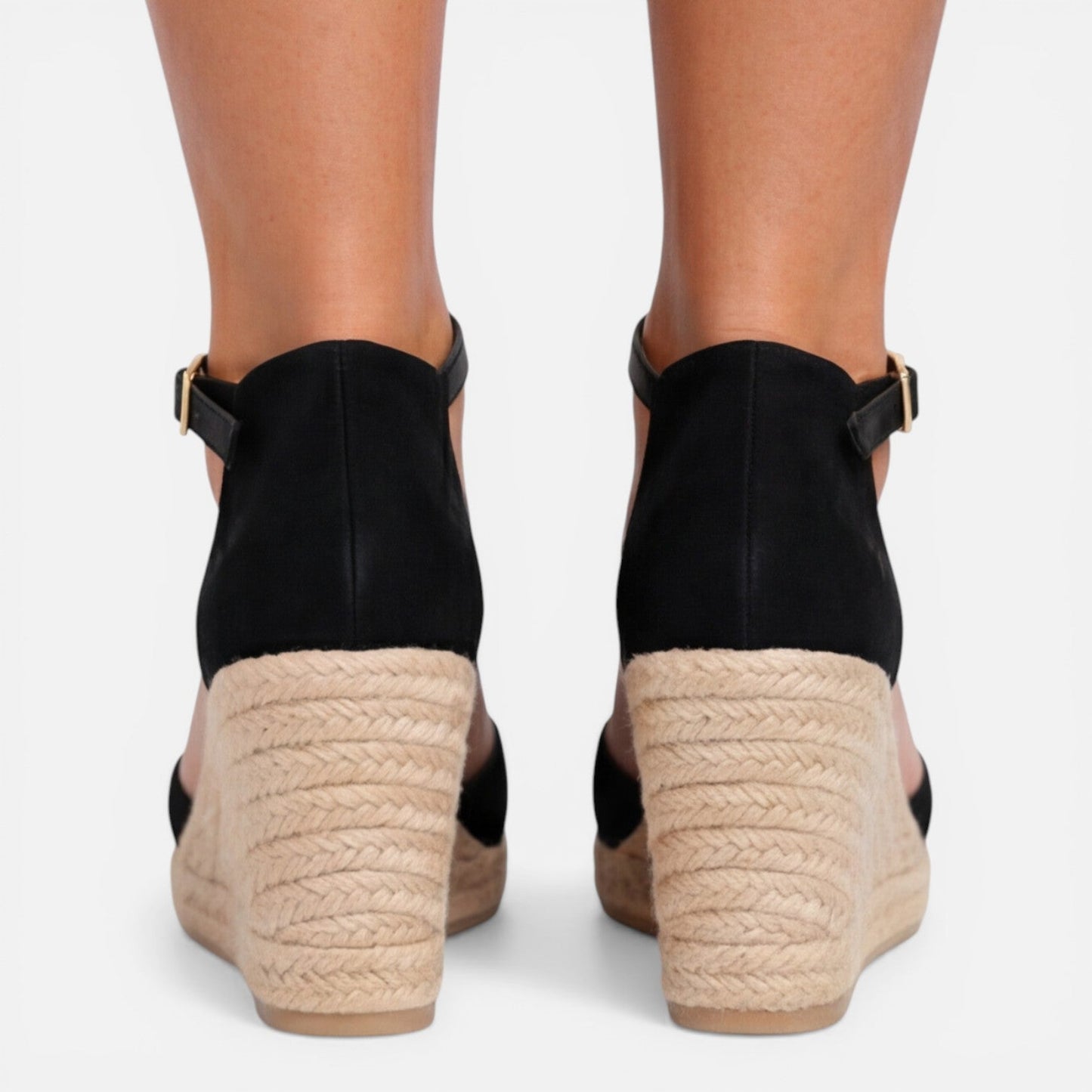 Back view of women's black closed toe espadrille wedges featuring adjustable ankle strap, jute wedge heel and suede finish by ILYNORA