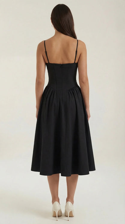 Back view of women's black corset fit and flare midi dress with structured silhouette and flowing midi skirt by ILYNORA