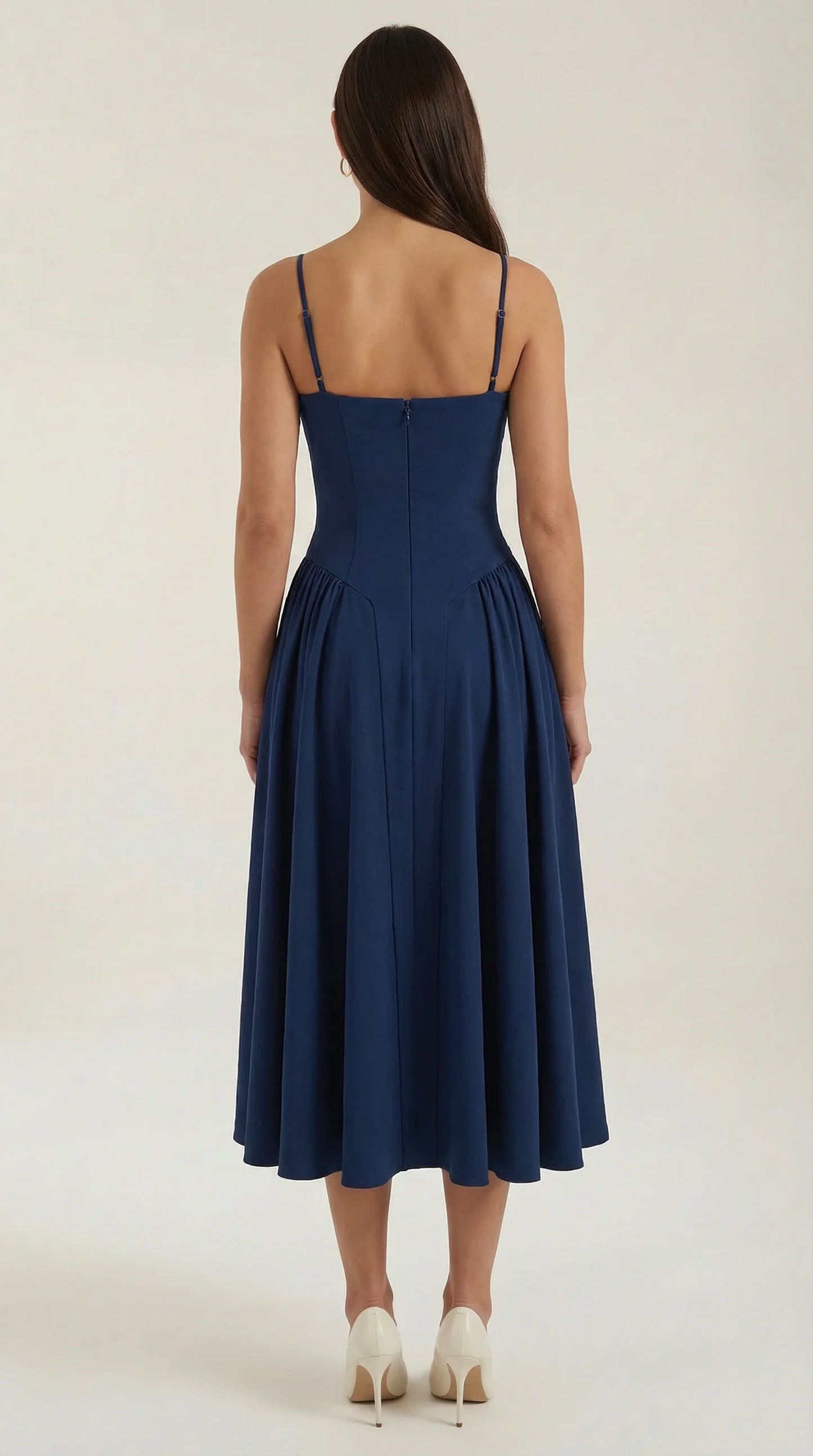 Back view of women's navy corset fit and flare midi dress with structured waist and flowing midi silhouette by ILYNORA