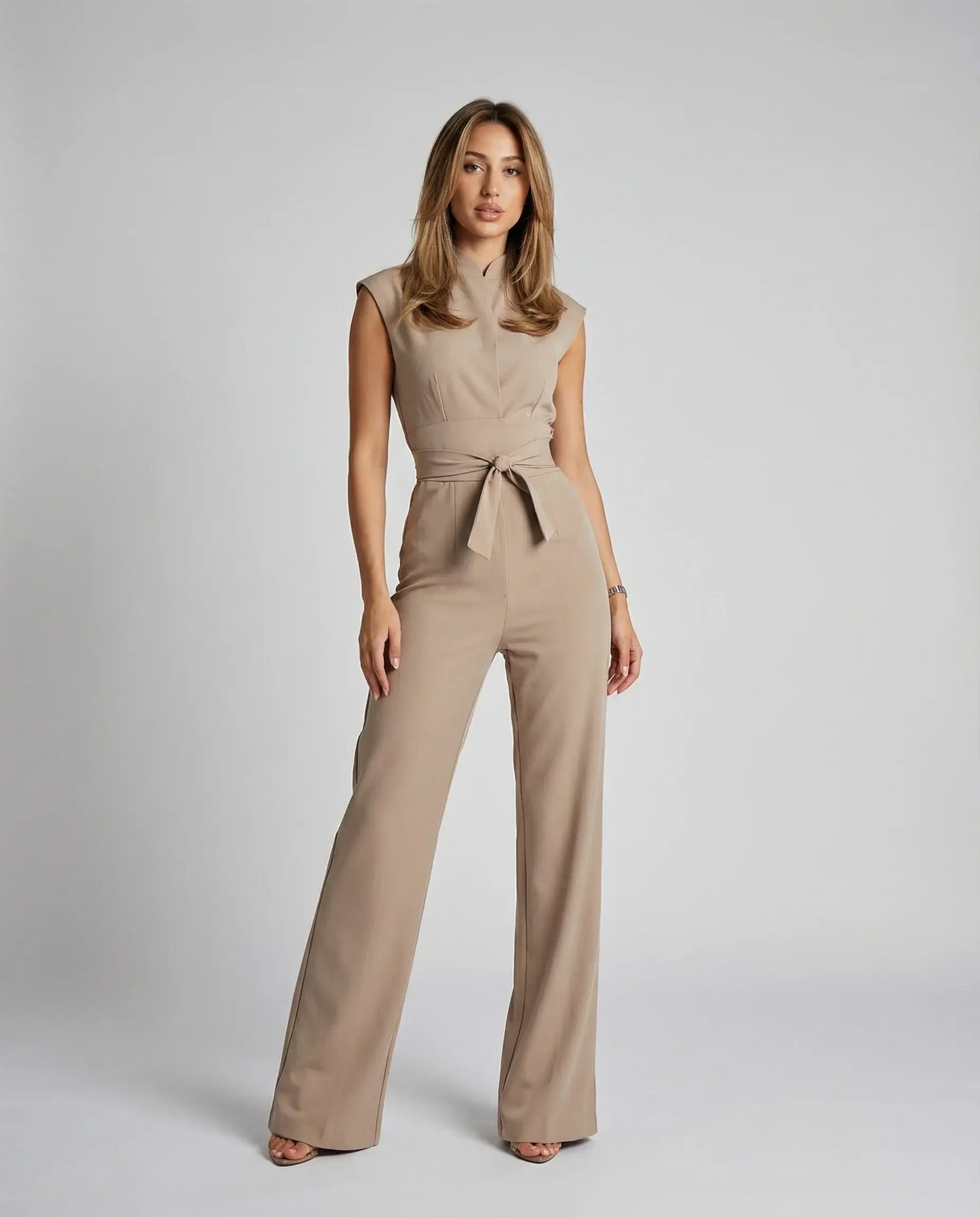 Beige sleeveless jumpsuit for women by Ilynora, front view with defined waist and wide-leg fit
