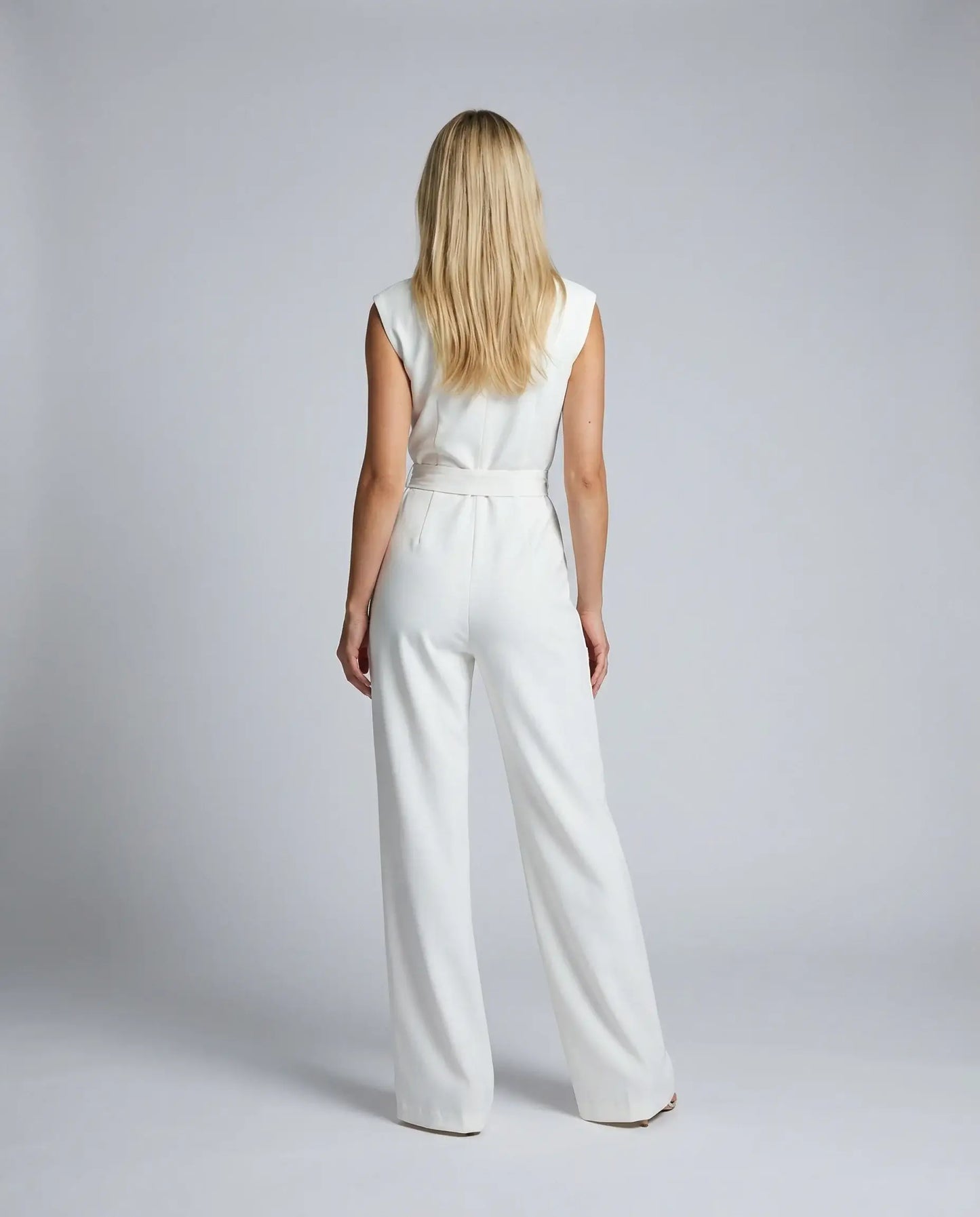 White sleeveless jumpsuit by Ilynora, back view with clean silhouette and elegant flow