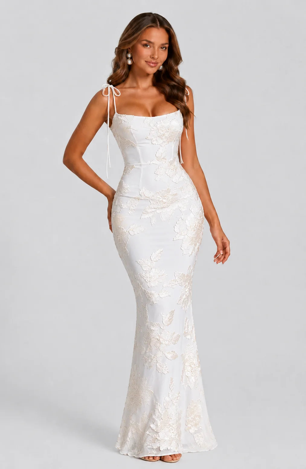 Women's ivory floral tie strap maxi dress with embroidered floral detailing, fitted silhouette and elegant wedding guest style by ILYNORA