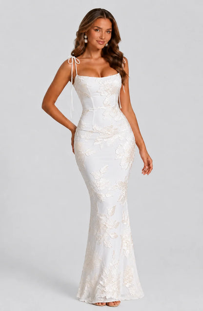 Women's ivory floral tie strap maxi dress with embroidered floral detailing, fitted silhouette and elegant wedding guest style by ILYNORA