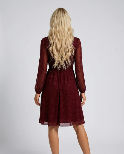 Red shimmer mini dress by Ilynora, back view with flowing skirt and elegant evening look