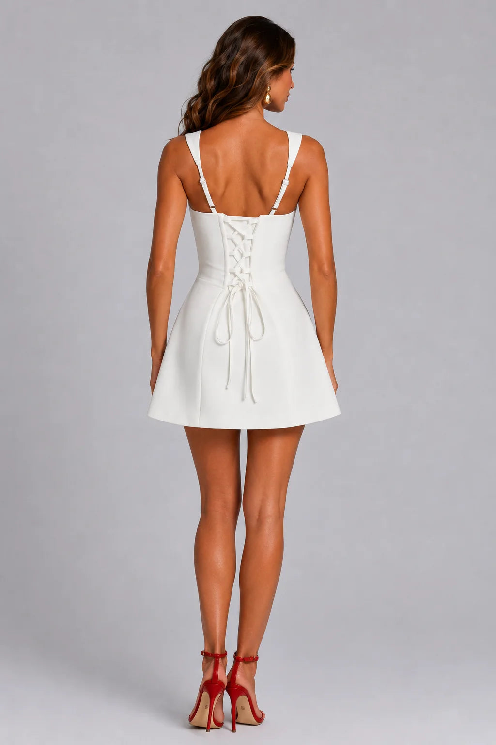 Back view of women's ivory square neck corset mini dress featuring lace-up back, flared skirt and tailored fit by ILYNORA